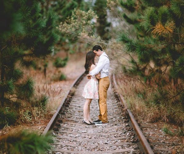 couple in love standing on railway tracks